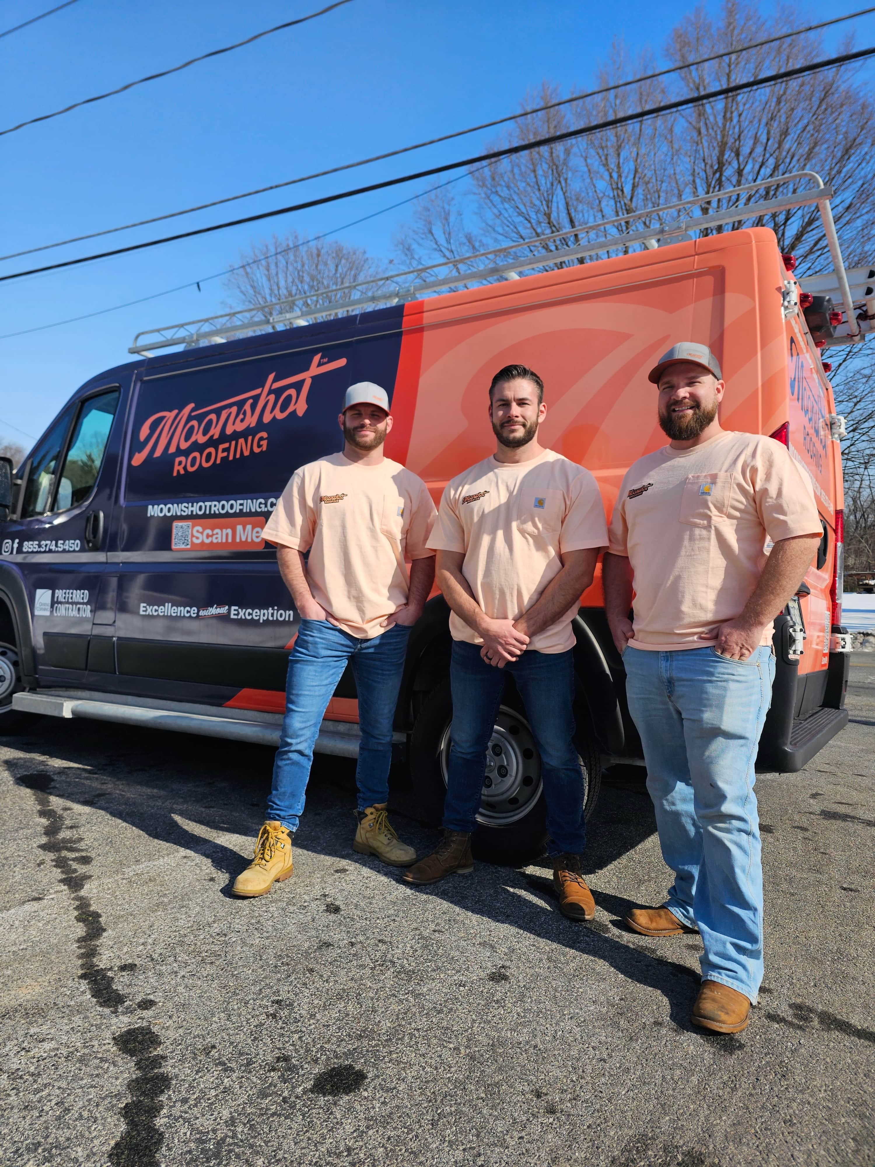 The Moonshot Roofing crew standing in front of the company's navy-and-orange branded van
